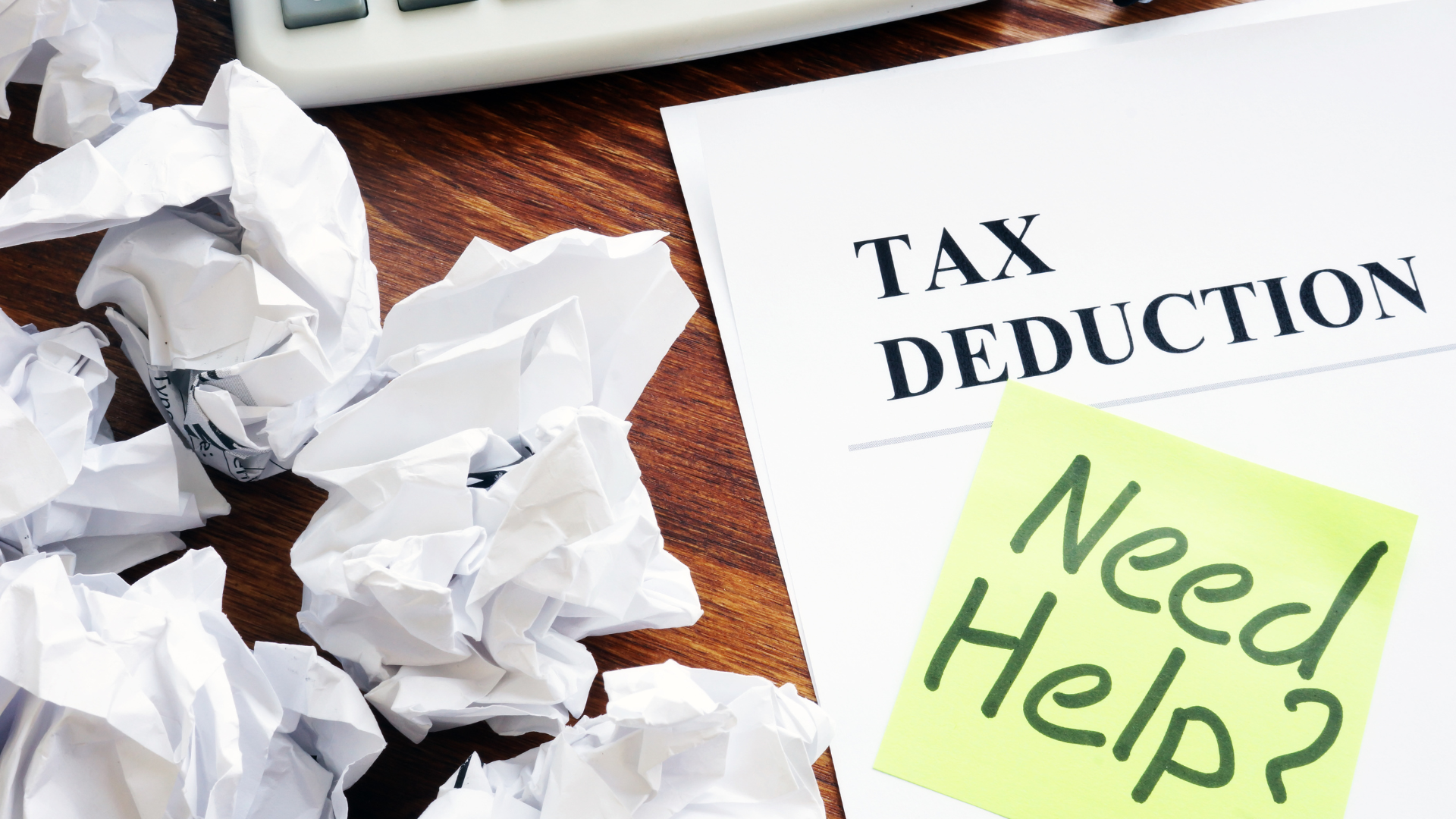 A document labeled "Tax Deduction" with a sticky note reading "Need Help?" sits on a desk near crumpled papers and a calculator, hinting at the stress of CRA audit preparation.